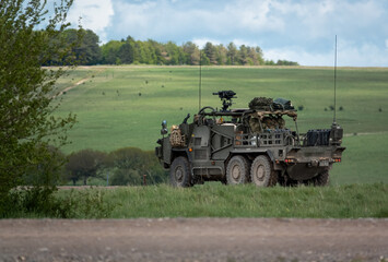 An army Supacat HMT 6x6 Coyote rapid assault, fire support and reconnaissance vehicle in action on a military exercise, Wiltshire UK