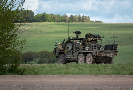 An army Supacat HMT 6x6 Coyote rapid assault, fire support and reconnaissance vehicle in action on a military exercise, Wiltshire UK