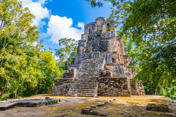 Fototapeta na wymiar Ancient Mayan site with temple ruins pyramids artifacts Muyil Mexico.