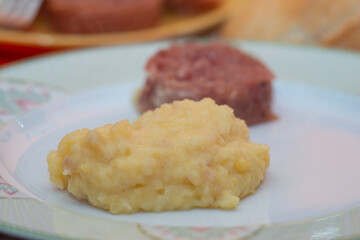 plate of cotechino and puree closeup on table