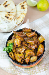 Typical and traditional food Colombia and Mexico. Chunchurria with arepa, corn tortilla, accompanied by lemon and onion. Colorful plate. Beef casings. Colorful plate on wooden background. Close up.