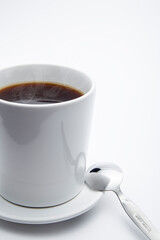 Cup of steaming coffee for morning breakfast on white background
