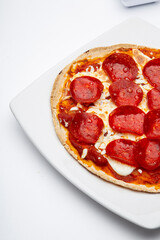 Delicious pepperoni pizza with cheese on white background
