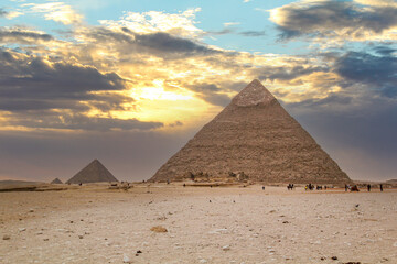 Fototapeta na wymiar The Giza pyramids from the backside, a street leading to the pyramids