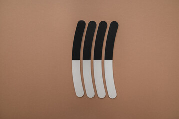 Set of nail files on a beige background. Top view with copy space