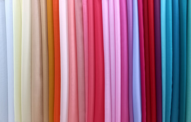 The assortment of silk fabrics in the store. Colorful, bright textiles. Collection of fabrics