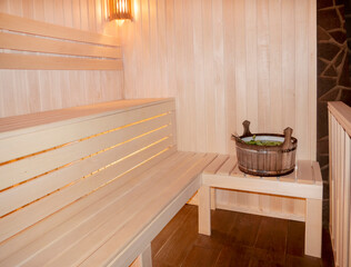 Fototapeta na wymiar Finnish sauna interior, classic wooden sauna, Russian sauna, sauna accessories in a village bath. SPA concept