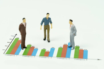 There are miniature figures of businessmen on the financial charts. Business - conversation