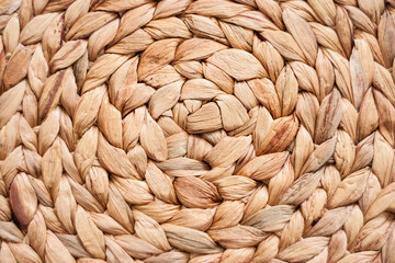 braided circle made of natural material in warm beige color.