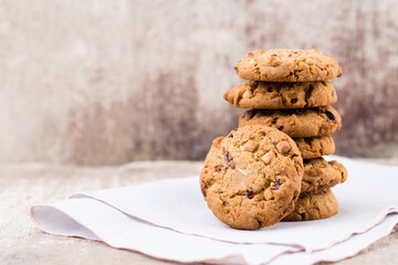 Chocolate oatmeal cookies on the wooden background.