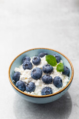 Cottage cheese with blueberry, fresh berries, keto healthy breakfast concept, top view.