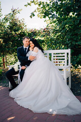 happy newlyweds on a park bench.