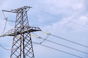 Steel pillar with high voltage electric power lines delivering electrical energy through cable wires on long distance