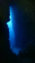 Fototapeta na wymiar cave diving underwater scuba divers exploring caves and having fun ocean scenery sun beams and rays background