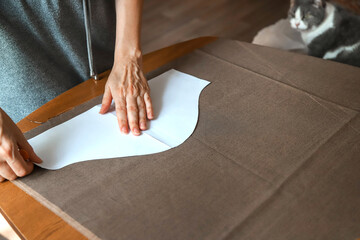 Working process of a dressmaker. Workplace at home. Photo of craftsperson's hands.
