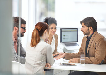 Teamwork gets business done. A group of businesspeople going over some plans together. © Yuri A/peopleimages.com