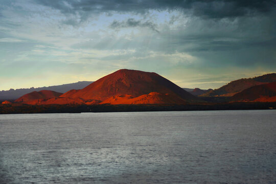 Red volcanic Island under a stormy sky in the Galapagos, Bartolome Island