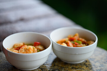 Shrimp soup with red pepper in white bowl