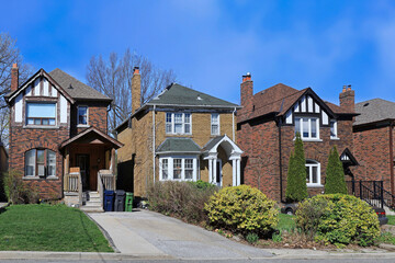 Fototapeta na wymiar Residential street with older two story brick detached houses in spring
