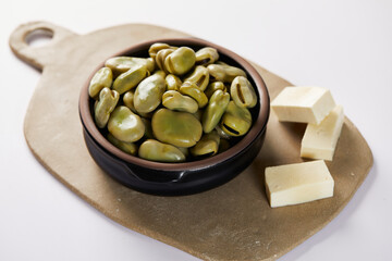 Broad beans with cheese, traditional Ecuadorian appetizer served in a typical deep dish with a white background