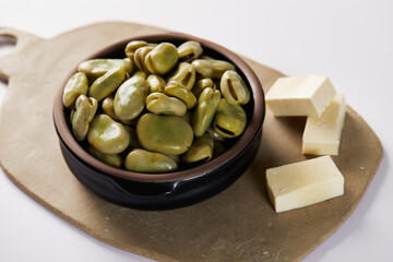 Broad beans with cheese, traditional Ecuadorian appetizer served in a typical deep dish with a white background