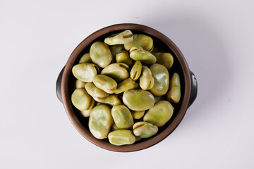 Broad beans with cheese, traditional Ecuadorian appetizer served in a typical deep dish with a white background