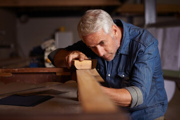 Woodwork pro. Shot of a mature male carpenter working on a project in his workshop.