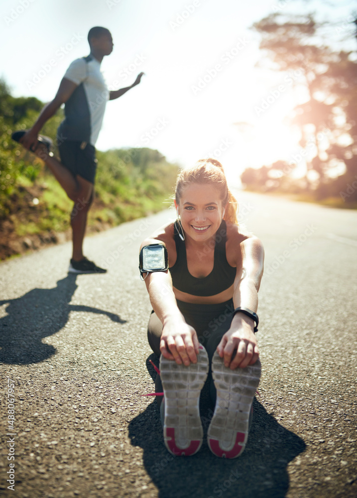 Sticker Preparing her muscles for an amazing workout. Shot of a young woman stretching before her run outdoors.