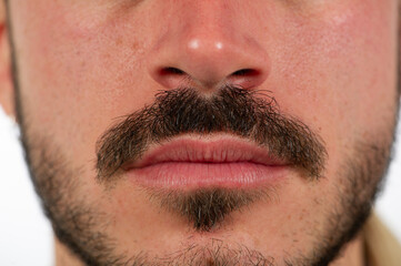 selective focus showing details of a boy's mustache and goatee