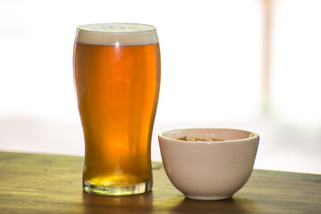 craft beer next to salted peanuts