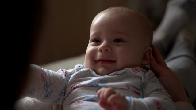 Newborn Baby With Young Mom look Into Each Other Eye. Cute Smiling Teethless Kid Face Portrait. Woman Kissing With Child Look At Camera. Infant, Mother Day, Childbirth, Beginning, Relationship Concept