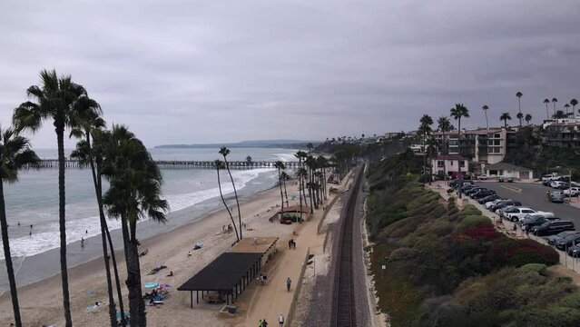 2022 - Excellent aerial view of a cloudy beach in San Clemente, California, and nearby railroad tracks.