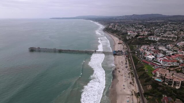 2022 - Excellent aerial view of a pier and beach in San Clemente, California on an overcast day.