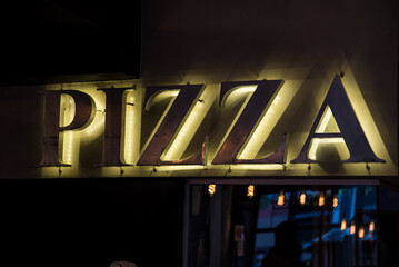 luminous pizza sign in a bar