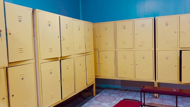 Changing room interior with closed and open lockers in swimming pool or gym