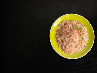 Himalayan pink salt, on a plate, and black background