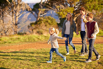 Frolicking with the family. Shot of a happy family out on a morning walk together.
