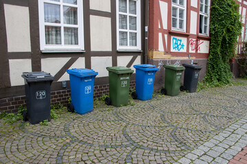 Waste separation in Germany. Various garbage cans in front of houses