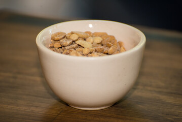 bowl with salted peanuts on a table
