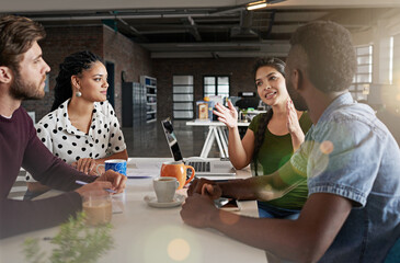 Their group synergy will lead them to success. Shot of a team of colleagues having a meeting in a modern office.
