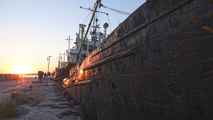 Old abandoned fishing boat at sunset