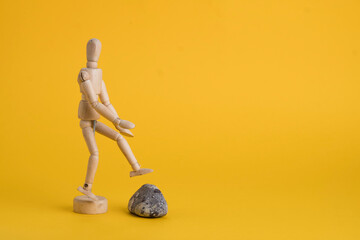 wooden fugurin on yellow background