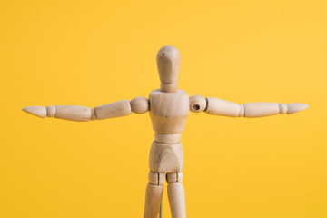 wooden mannequin holding something