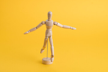 wooden fugurin on yellow background