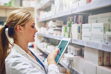 Doing what it takes to give you the best care. Shot of a pharmacist using her digital tablet while...