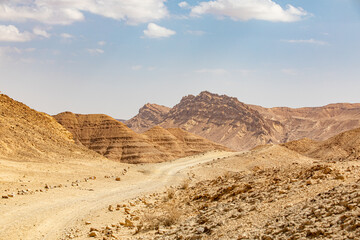 Mountains, rocks and hills of Judean desert in Israel, Middle East landmarks of Old Testament Bible times. Aerial view of Dead sea spa and recreation areas. High quality photo - obrazy, fototapety, plakaty