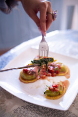 person cutting homemade pasta on a plate
