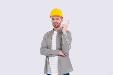 Construction Worker Having A Great Idea. Man with Idea Holding Finger Up. Worker in Hard Helmet Isolated