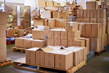 Pallets ready to go. Shot of stacked boxes in a large distribution warehouse.