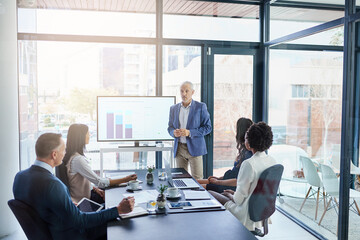 Hes a pro at presentations. Cropped shot of a businessman giving a presentation in a boardroom.